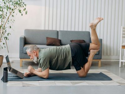 Man holding a plank position with perfect form on a yoga mat.