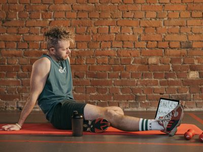 Profile view of a man meditating after a workout session.